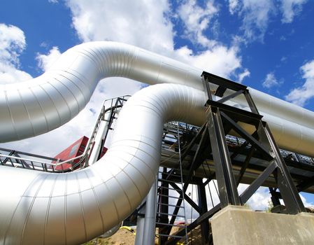 Industrial zone, Steel pipelines and valves against blue sky