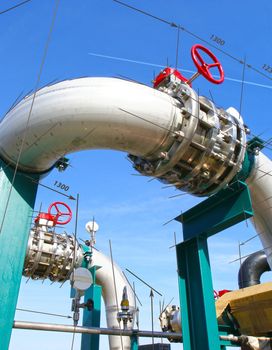 Industrial zone, Steel pipelines and valves against blue sky