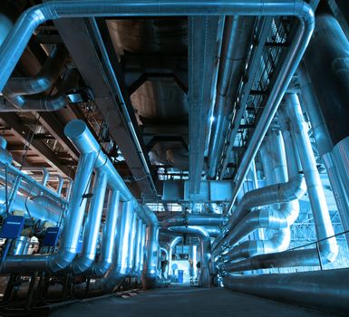 Equipment, cables and piping as found inside of a modern industrial power plant