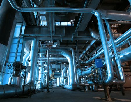 Equipment, cables and piping as found inside of a modern industrial power plant