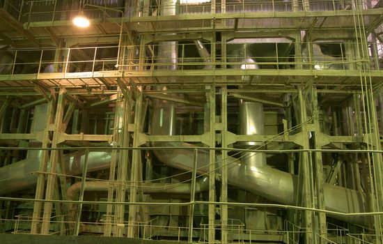 Equipment, cables and piping as found inside of a modern industrial power plant