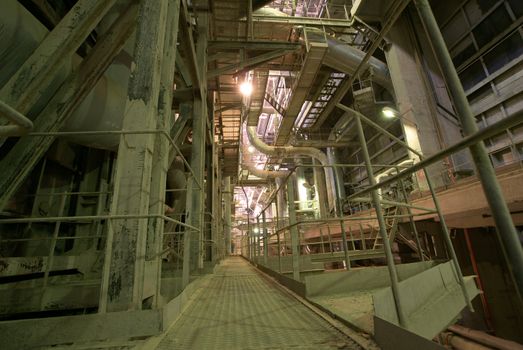 Equipment, cables and piping as found inside of  industrial power plant