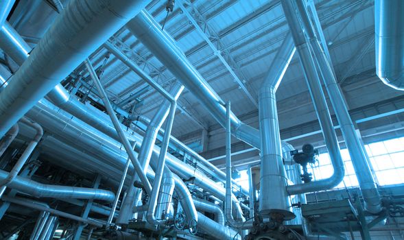 Equipment, cables and piping as found inside of  industrial power plant