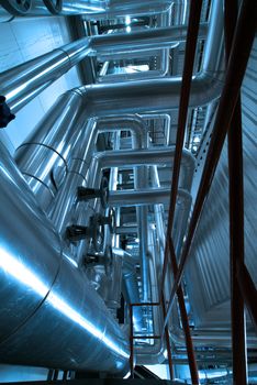 Equipment, cables and piping as found inside of  industrial power plant