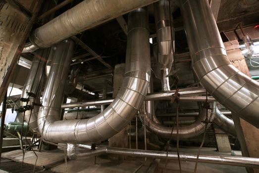 Equipment, cables and piping as found inside of  industrial power plant