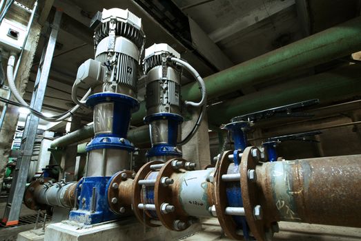 pumps, cables and piping as found inside of  industrial power plant