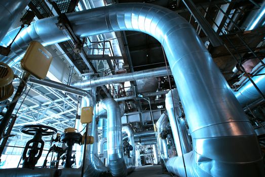 Equipment, cables and piping as found inside of  industrial power plant