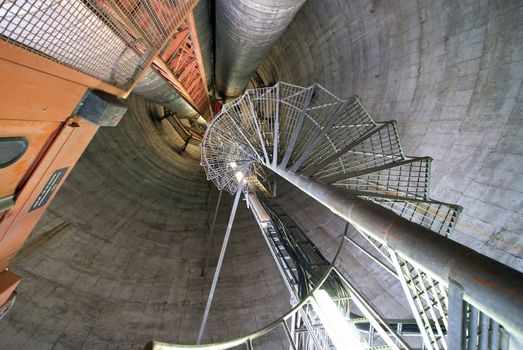 Equipment, cables and stairs as found inside of  industrial power plant