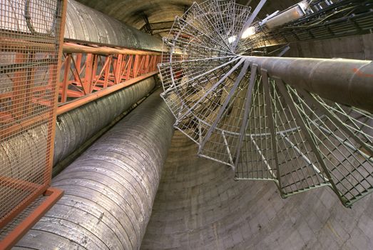 Equipment, cables and piping as found inside of  industrial power plant