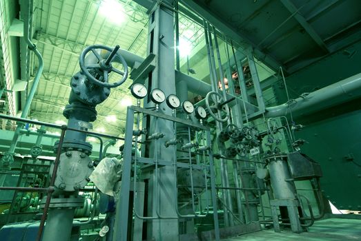 Equipment, cables and piping as found inside of  industrial power plant