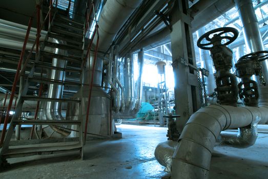 Equipment, cables and piping as found inside of  industrial power plant