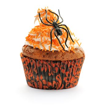 Halloween cupcake with whipped cream and decoration isolated on white