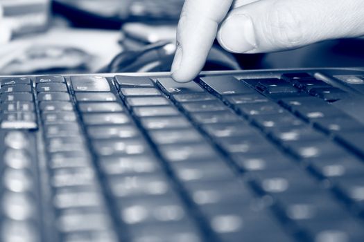 Man's finger on "enter" key