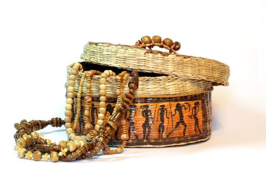 wooden and ivory beads in a handmade african box on a white background