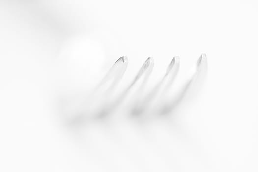 The fork on the white background, shallow shallow depth of field