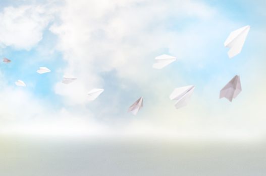 Paper airplanes fly over abstract background of clouds, space for text