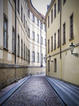 Narrow alley in Prague with cobbled road in January