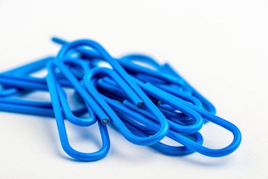 Blue paperclips on white background