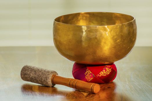 Sound bowl on a table with red bolster