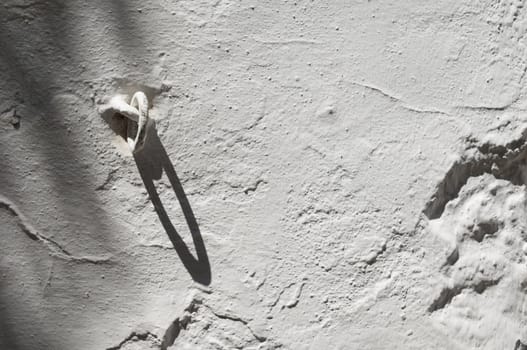 Old iron ring in a traditional whitewashed wall, Portugal