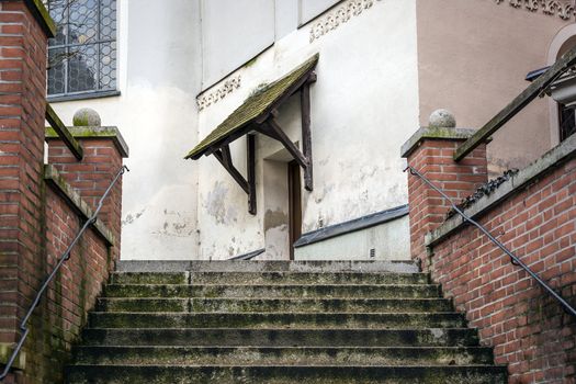 Stairs to the entrance of a church with red bricks walls in the town Dachau, Germany