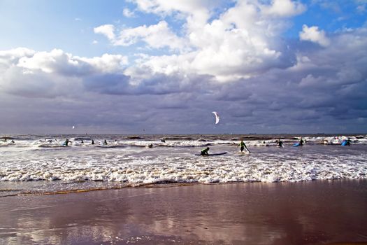 Surfers surfing at Scheveningen in the Netherlands