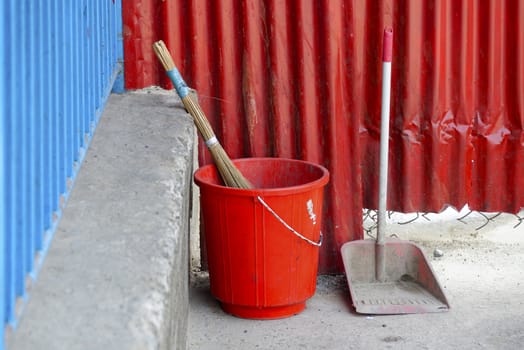 Red plastic bucket, broom and scoop