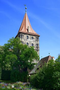 Tower of Nuremberg Castle with tree and flowers