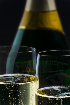 Champagner bottle with two glasses on black background