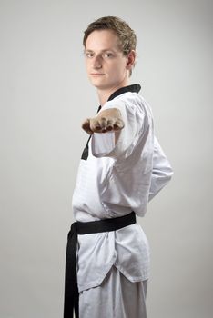 Taekwon-Do champoin on a grey background and tiled floor