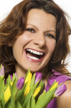 Smiling woman with pink and yellow tulips
