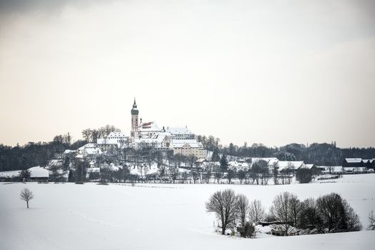 Monastery Andechs in winter landscape with snow