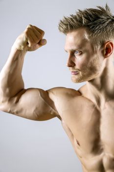 Biceps muscle of a young athletic blond man