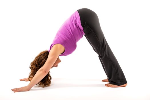 Pretty woman performing the yoga exercise Adho Mukha Svanasana