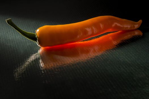 Image of an orange peppers with dark background