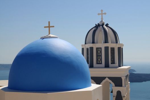 two domes with a cross of a church on Santorini