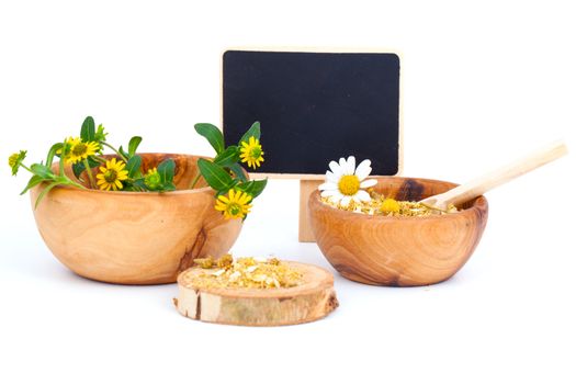 Healing herbs in wooden bowl. Alternative medicine concept