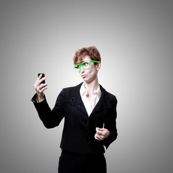 business woman with phone on gray background