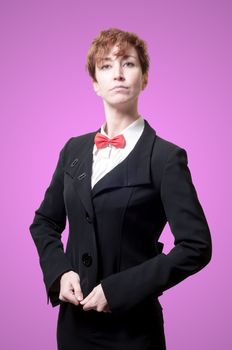 elegant businesswoman with bow tie on pink background