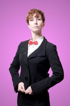 elegant businesswoman with bow tie on pink background