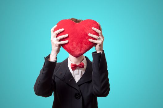 elegant businesswoman with heart pillow on blue background