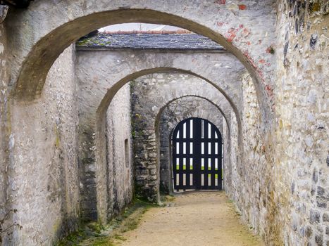 Archway of a castle in winter with wooden gate