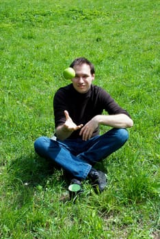 man sitting on green grass