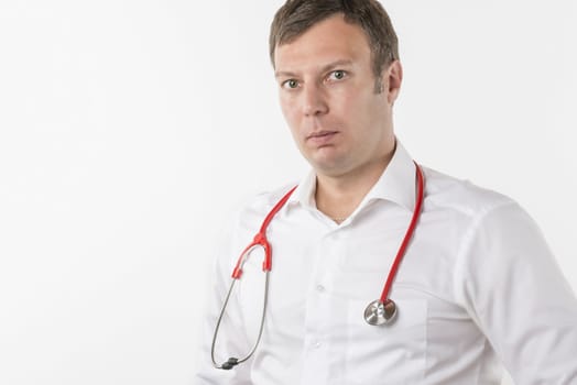Man in white shirt with red stethoscope on white background