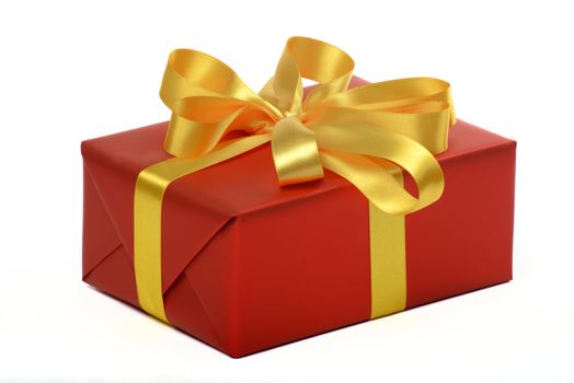 gift with gold ribbon in red paper on white underground