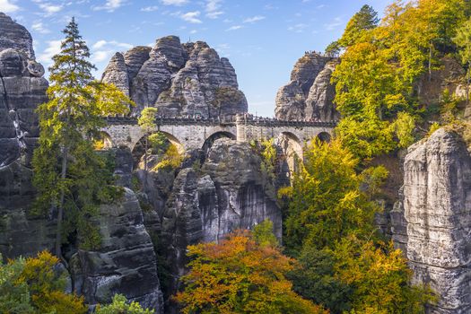 Bridge named Bastei in Saxon Switzerland Germany on a sunny day in autumn with colored trees and leafs