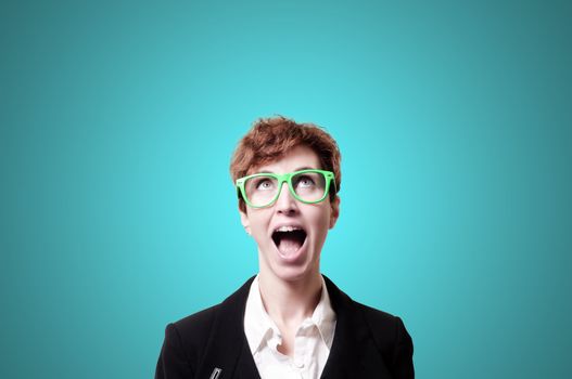 screaming business woman with green eyeglasses on blue background