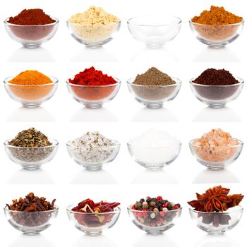 Variety of different spices in glass bowls for seasoning, isolated on white background