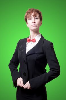 elegant businesswoman with bow tie on green background