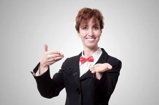 elegant businesswoman with bow tie showing on gray background